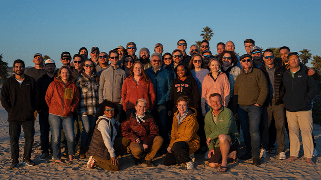 REC Solar company group photo at the beach